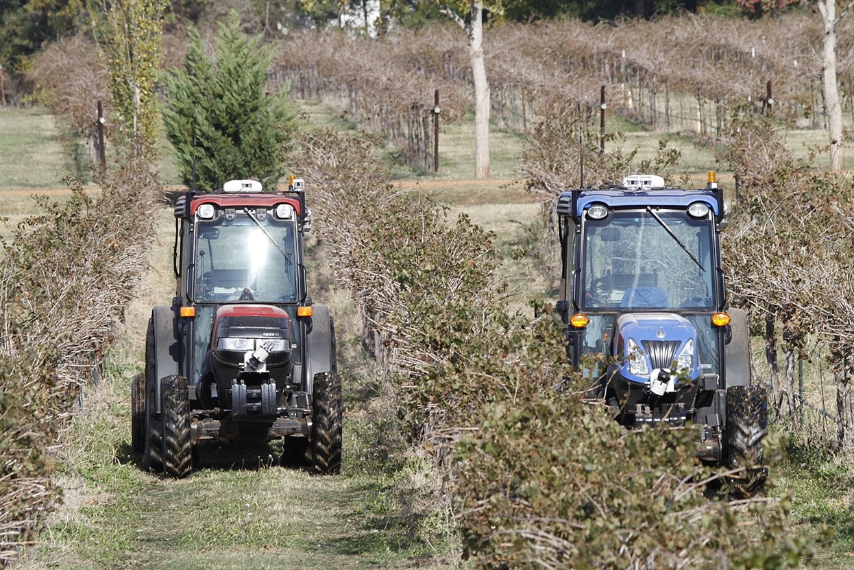 Photo, Two autonomous compact tractors