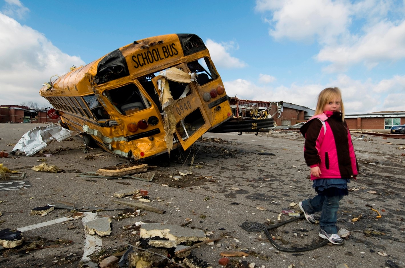 photo of child walking among debris