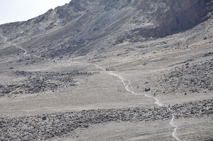 A higher elevation trail runs across a dry alpine desert