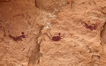 Three of the many swimmers depicted in the Cave of the Swimmers