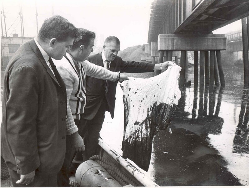 Three Cleveland city councilmen inspect evidence of oil pollution