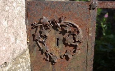 Rust forms on an intricately decorated iron lock
