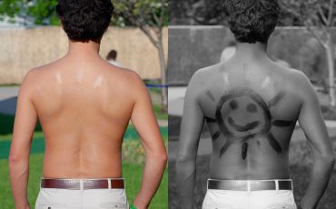 Sunscreen SPF 30 applied to a man’s back and photographed using normal and UV photography at a science festival.