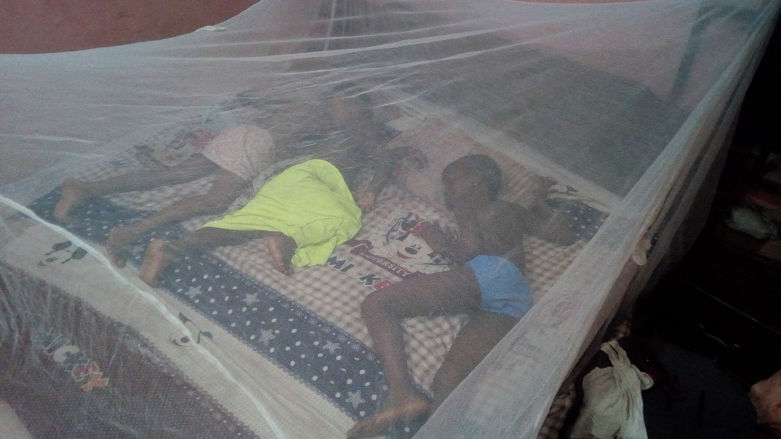 Sleeping under an insecticide treated net to avert malaria in Africa.
