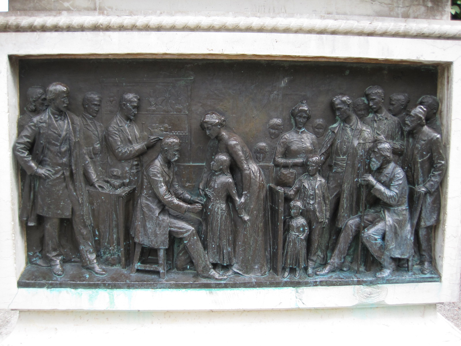 A bronze sculpture on the base of a monument to Pasteur at his home in Arbois, France, depicts his work in healthcare.