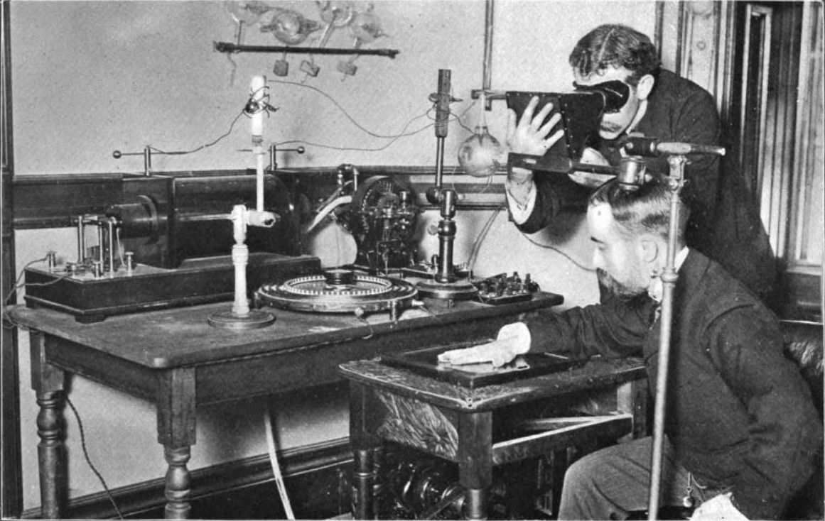 experimenters taking an X-ray with an early Crookes tube