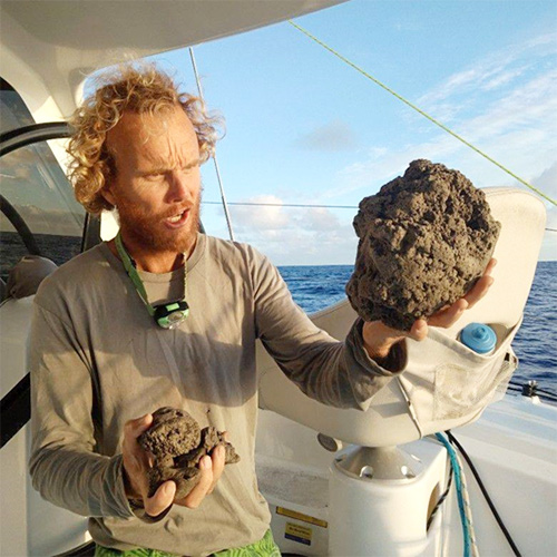 Sailor Michael Hoult with chunks of pumice from the 2019 eruption 