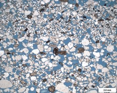 Photomicrograph of a sandstone with blue epoxy filling its pore space