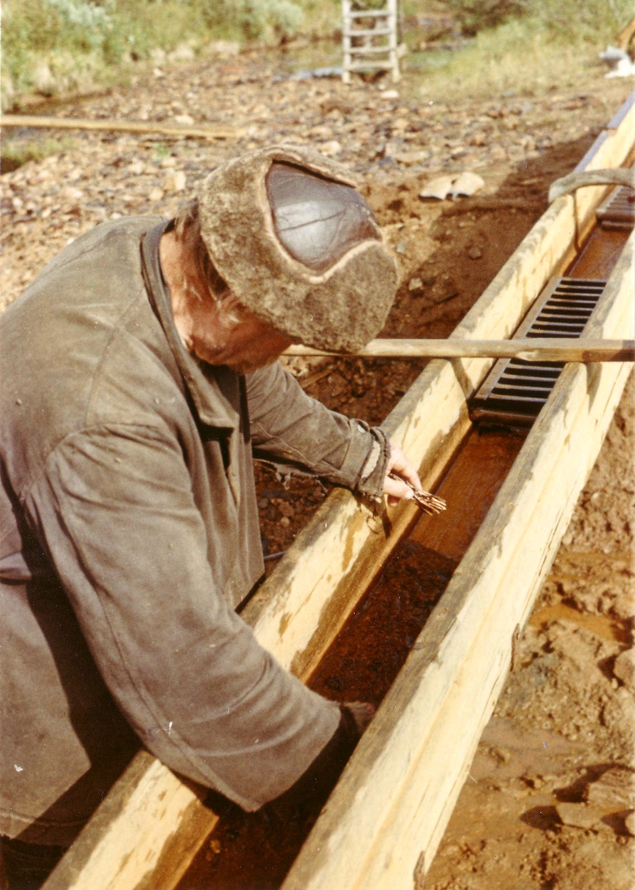 Miner using a sluice